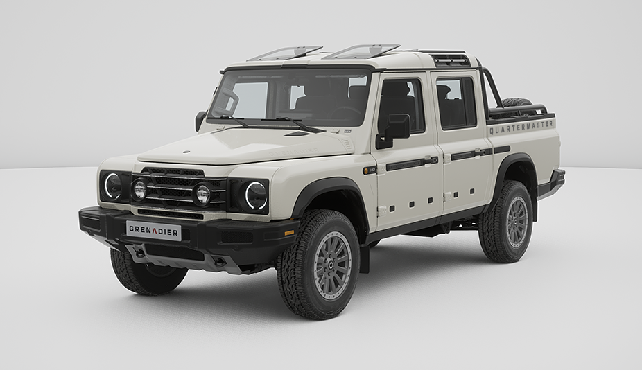 Ineos Grenadier Quartermaster Fieldmaster Edition to terenowy samochód typu pickup. Ma masywną sylwetkę, białe nadwozie i potężne opony.